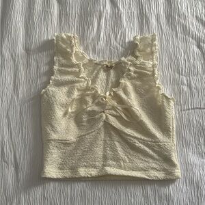 Cream cropped top with lace detailing on the front